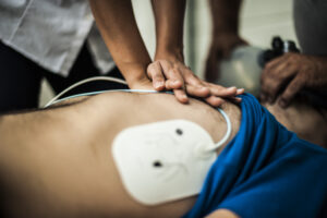 cardiac arrest with cpr and aed pads in place